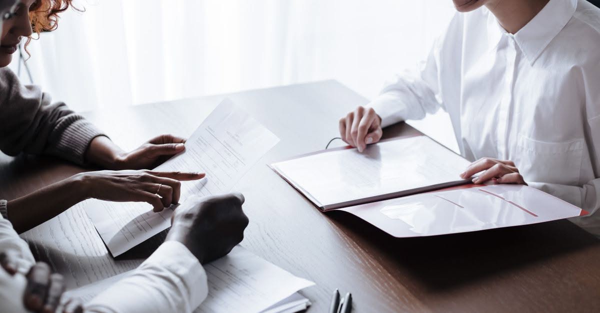 What Actually Disqualifies Someone From Becoming a Foster Parent in Pennsylvania A diverse group of adults reviewing documents during a meeting at an office table.